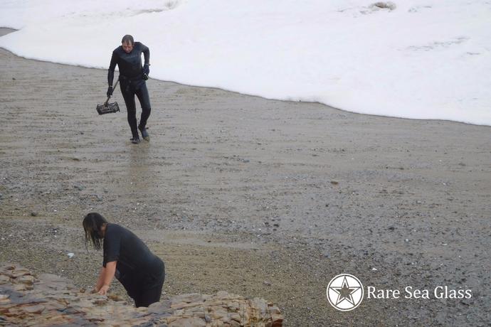 Sea glass hunter in a wetsuit at Davenport Beach